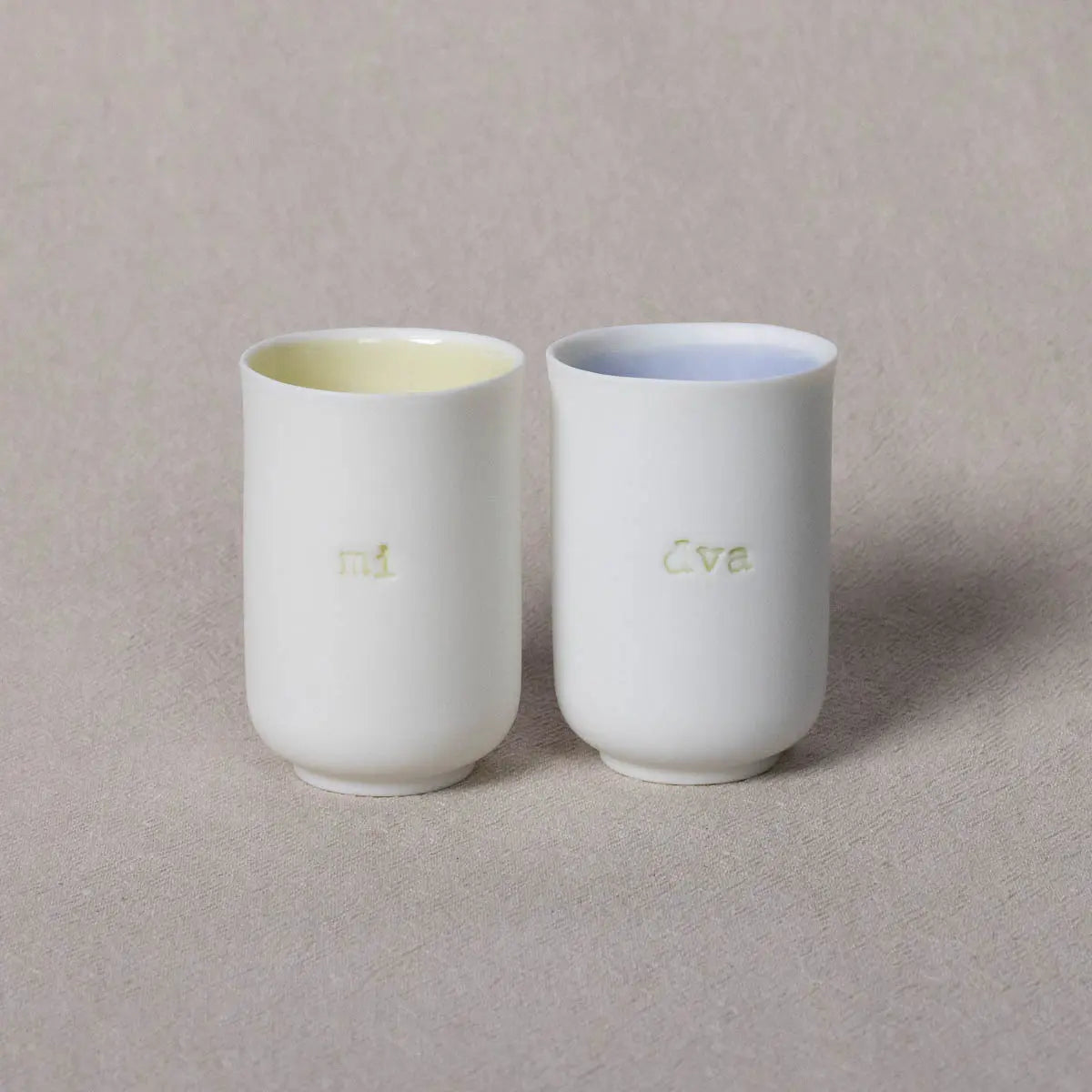 The Soulmates porcelain coffee set of two cups, featuring the "mi dva" inscription, adds an elegant touch for minimalism enthusiasts when placed side by side on a neutral surface. This handmade set from Urchic Porcelain is perfect for your serene mornings.